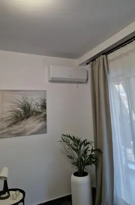 a room with a window with a plant in a vase at Cozy apartment in Athens in Athens