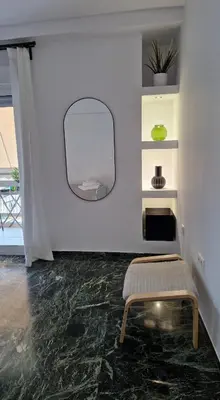 a room with a mirror and a bench in it at Cozy apartment in Athens in Athens