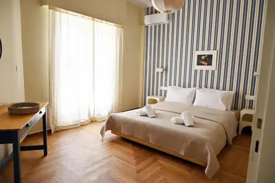 a bedroom with a bed with two towels on it at Brand New! Vintage Charm, Modern Comfort in Athens