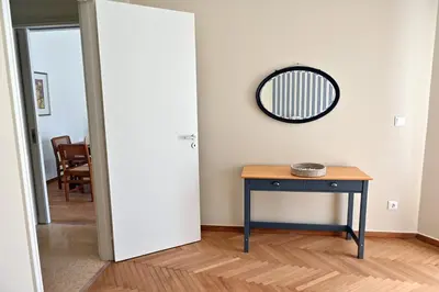 a room with a table and a mirror on the wall at Brand New! Vintage Charm, Modern Comfort in Athens