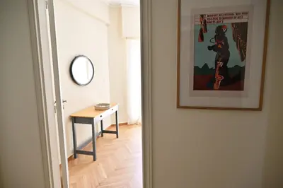 a hallway with a table and a picture on the wall at Brand New! Vintage Charm, Modern Comfort in Athens