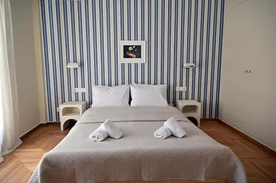 a bedroom with a large bed with towels on it at Brand New! Vintage Charm, Modern Comfort in Athens