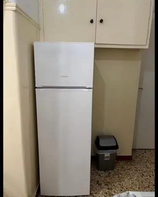 a white refrigerator in the corner of a kitchen at Dream room 3-4 in Athens