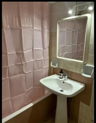 a bathroom with a sink and a pink shower curtain at Dream room 3-4 in Athens