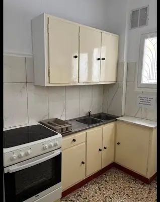 a kitchen with white cabinets and a sink at Dream room 3-4 in Athens