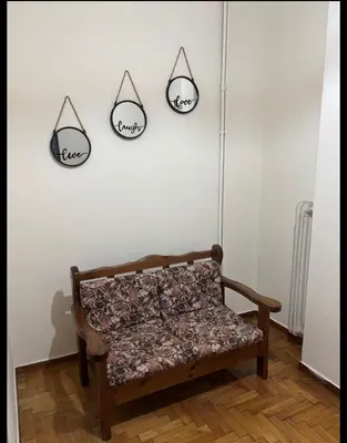a bench in a room with three hooks on the wall at Dream room 3-4 in Athens