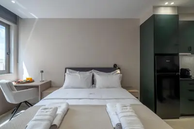 a bedroom with a large bed with a green cabinet at Agora Views in Athens
