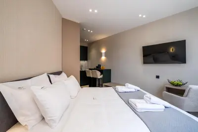 a bedroom with a large white bed with white pillows at Agora Views in Athens