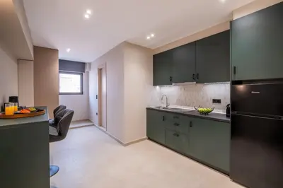 a kitchen with green cabinets and a counter top at Agora Views in Athens