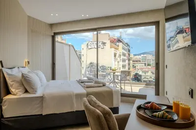 a bedroom with a bed and a large window at Agora Views in Athens
