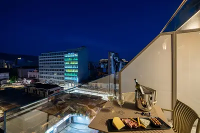 a table on a balcony with a view of a city at Agora Views in Athens