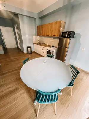 a kitchen with a table and chairs in a room at Studios & Shared Roof to Acropolis in Athens