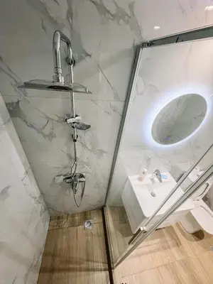a bathroom with a shower and a sink at Studios & Shared Roof to Acropolis in Athens