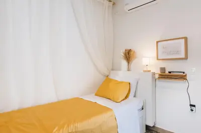 a small bedroom with a bed and a window at MrK Rooftop 2 in Athens