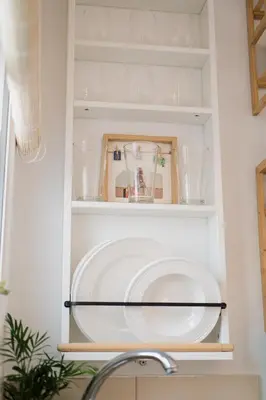 a kitchen pantry with plates and glasses on shelves at MrK Rooftop 2 in Athens