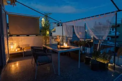 a patio with a table and chairs on a balcony at MrK Rooftop 2 in Athens