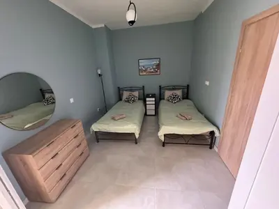 a small room with two beds and a mirror at Athens station 4 min walk , two bedroom apartment in Athens