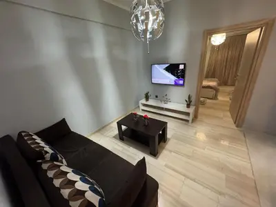 a living room with a couch and a tv at Athens station 4 min walk , two bedroom apartment in Athens