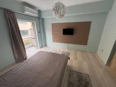 a living room with a flat screen tv on the wall at Athens station 4 min walk , two bedroom apartment in Athens