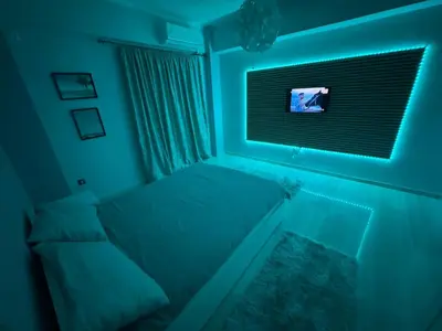 a bedroom with a bed and a tv in a blue room at Athens station 4 min walk , two bedroom apartment in Athens