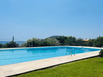 a swimming pool in the middle of a yard at Villa Femy - 3 bedrooms, shared pool with 1 house in Anavissos