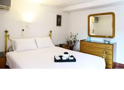 a white bed with a mirror and a tray on it at Villa Femy - 3 bedrooms, shared pool with 1 house in Anavissos