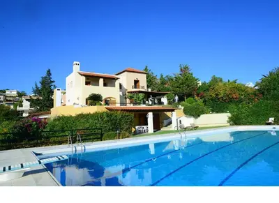 a large swimming pool in front of a house at Villa Femy - 3 bedrooms, shared pool with 1 house in Anavissos