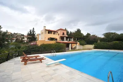a swimming pool with a bench and a house at Villa Femy - 3 bedrooms, shared pool with 1 house in Anavissos