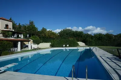 a large swimming pool with blue water at Villa Femy - 3 bedrooms, shared pool with 1 house in Anavissos