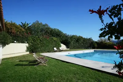 a swimming pool in the yard of a house at Villa Femy - 3 bedrooms, shared pool with 1 house in Anavissos