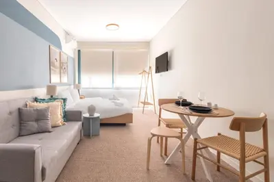 a living room with a couch and a table at Zen Ermou City Center 2 in Athens