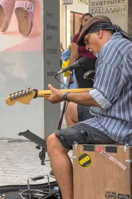 a man playing a musical instrument with a guitar at Zen Ermou City Center 2 in Athens