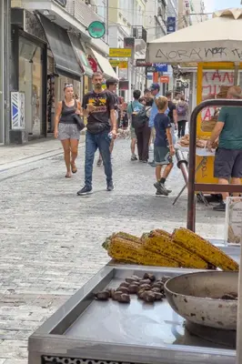 a group of people walking down a street at Zen Ermou City Center 2 in Athens