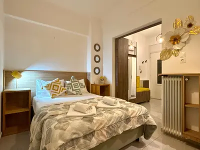a bedroom with a large bed and a large mirror at Acropolis Gem in Central Athens in Athens