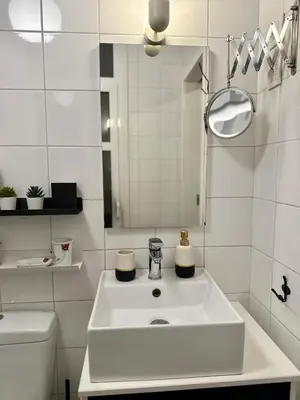 a white bathroom with a sink and a toilet at Acropolis Gem in Central Athens in Athens