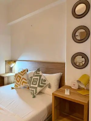 a bedroom with a bed and two mirrors on the wall at Acropolis Gem in Central Athens in Athens