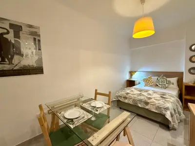 a bedroom with a bed and a glass table at Acropolis Gem in Central Athens in Athens
