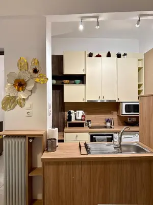a kitchen with white cabinets and a sink at Acropolis Gem in Central Athens in Athens