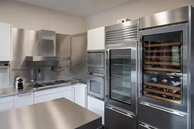 a kitchen with stainless steel appliances and a counter at Calm Retreat Villa Lagonisi in Kalívia Thorikoú