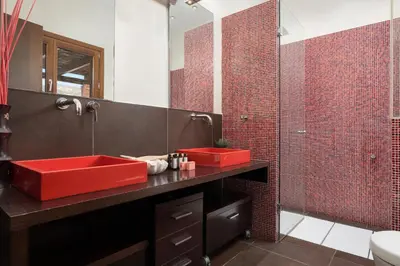 a bathroom with a red sink and red tiles at Calm Retreat Villa Lagonisi in Kalívia Thorikoú