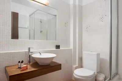 a white bathroom with a sink and a toilet at Calm Retreat Villa Lagonisi in Kalívia Thorikoú
