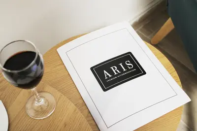 a box with a glass of wine on a table at ARIS- King suite on the boulevard in Athens