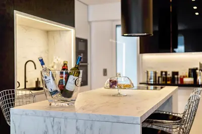 a counter with two bottles of alcohol on it at Luxury 3-bedroom Apartment Athens Nea Smirni in Athens