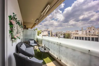 a balcony with chairs and a table and a view at Luxury 3-bedroom Apartment Athens Nea Smirni in Athens