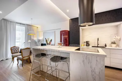 a kitchen with a large marble counter and chairs at Luxury 3-bedroom Apartment Athens Nea Smirni in Athens