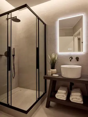 a bathroom with a glass shower and a sink at Acropolis Eclectic Residence in Athens