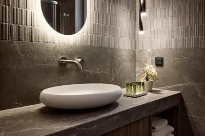 a bathroom with a white sink on a counter at Acropolis Eclectic Residence in Athens