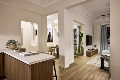 a living room with a kitchen and a dining room at Acropolis Eclectic Residence in Athens