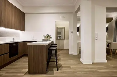 a kitchen with a counter and a bar with stools at Acropolis Eclectic Residence in Athens
