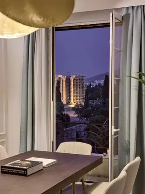 a dining room table with a view of a city at Acropolis Eclectic Residence in Athens